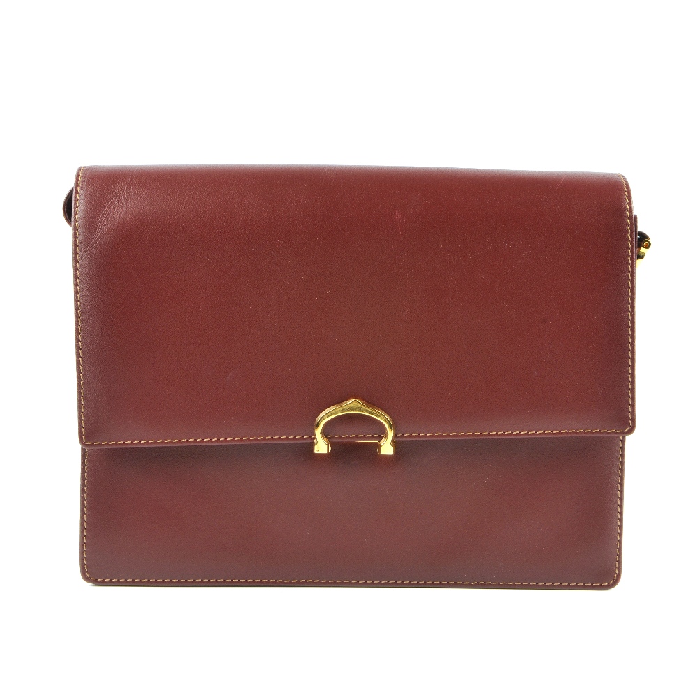 CARTIER - a Bordeaux leather satchel. Crafted from maker's classic burgundy leather, featuring