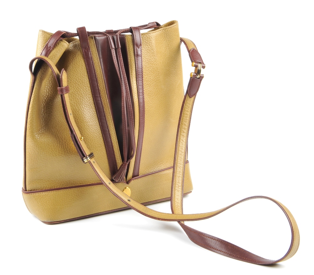 CARTIER - a two-tone bucket tote handbag. Designed with a pebbled mustard leather exterior and - Image 4 of 7