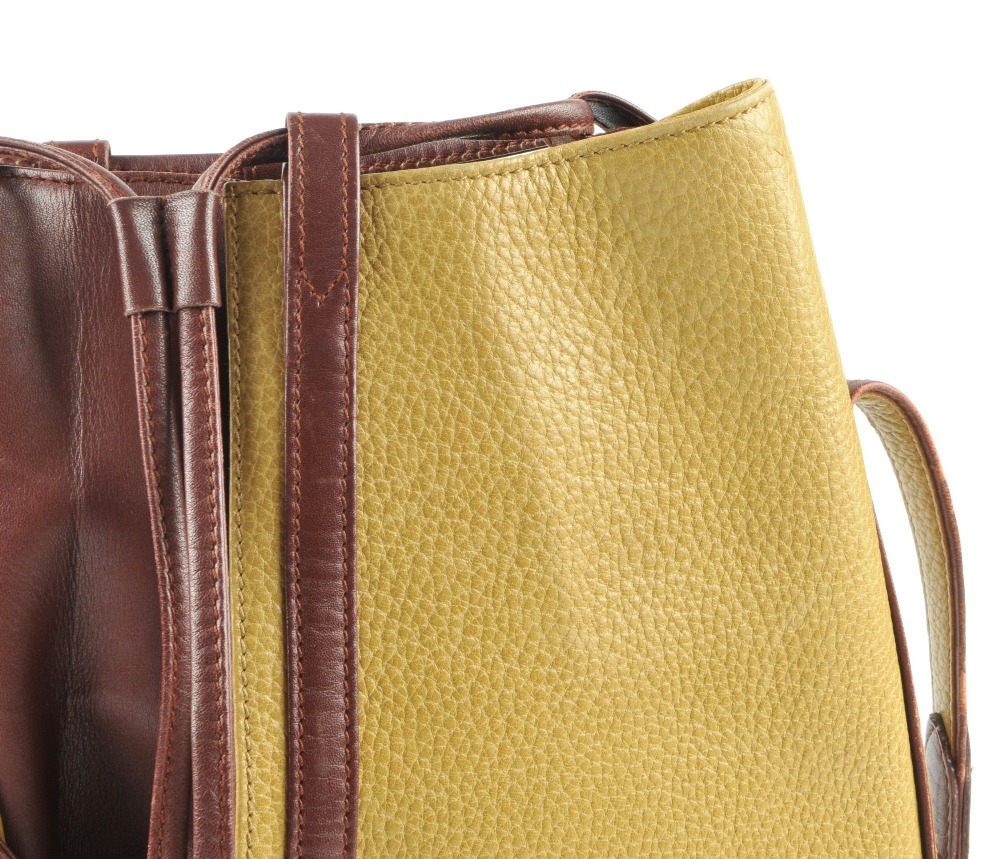 CARTIER - a two-tone bucket tote handbag. Designed with a pebbled mustard leather exterior and - Image 2 of 7