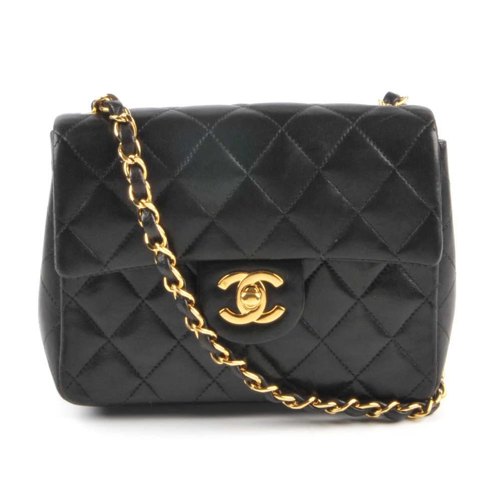 CHANEL - a Mini Classic Flap handbag. Featuring maker's signature black quilted lambskin leather