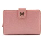 CHANEL - a pink embossed lambskin wallet. The leather with embossed camellia and 'CC' logo