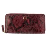 COACH - a pink faux snakeskin wallet. With pink enamel logo badge to the front, wraparound zip