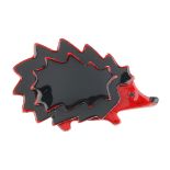 LEA STEIN - a hedgehog brooch. The black plastic body with red edge to the red plastic face and