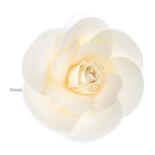 CHANEL - a flower brooch. The petals made from cream satin-like fabric, with plastic stamen