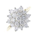 An 18ct gold diamond cluster ring. Of hexagonal outline, the brilliant-cut diamond, within a