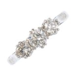 A diamond three-stone ring. The graduated brilliant-cut diamond line, with tapered shoulders and