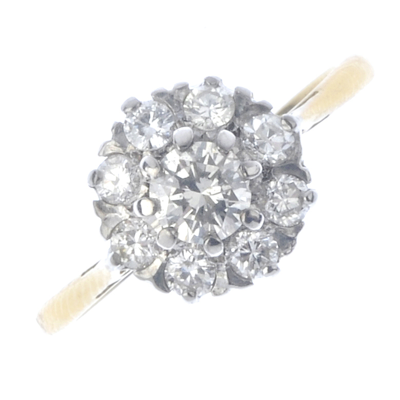 An 18ct gold diamond cluster ring. The brilliant-cut diamond, with circular-cut diamond surround.