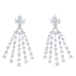 A pair of diamond earrings. Each designed as a graduated brilliant-cut diamond line fringe,