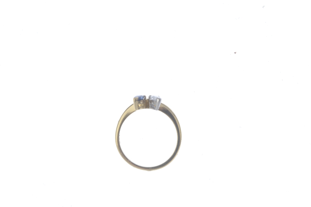 An 18ct gold diamond and sapphire dress ring. The crossover band, with pear-shape diamond and - Image 2 of 4