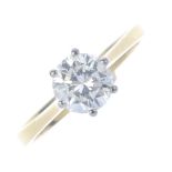 An 18ct gold diamond single-stone ring. The brilliant-cut diamond, with bi-colour gallery and