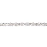 A diamond bracelet. Designed as a series of brilliant-cut diamond floral clusters, with bar