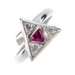 An 18ct gold diamond and ruby dress ring. Of triangular outline, the triangular-shape ruby, within a