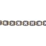 A smoky quartz bracelet. Designed as a series of oval-shape smoky quartz links, with partially