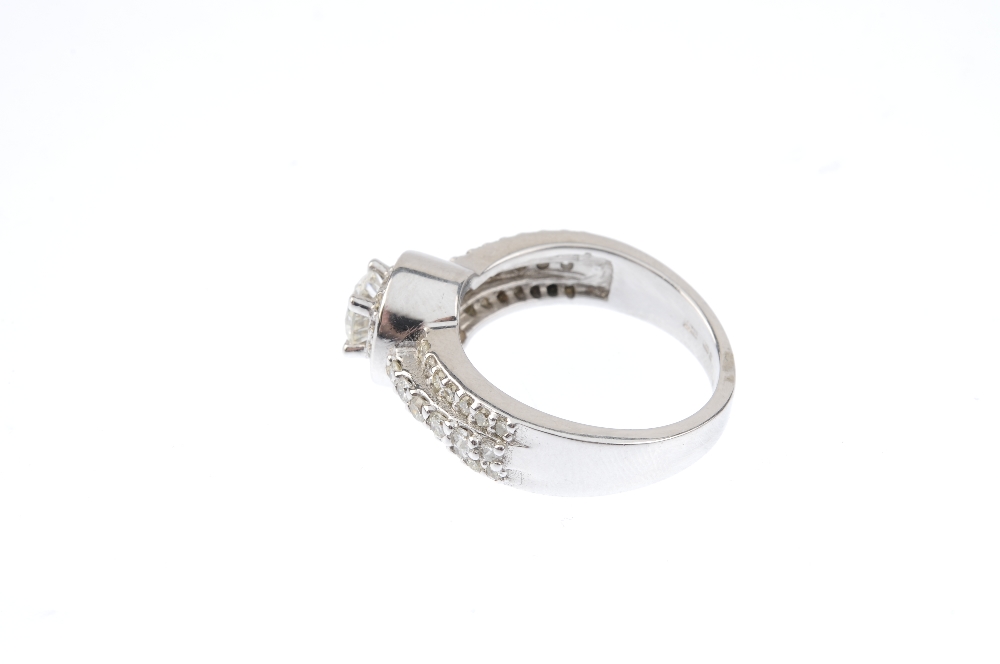 A 14ct gold diamond dress ring. The brilliant-cut diamond, with similarly-cut diamond surround and - Image 2 of 3