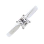 A platinum diamond single-stone ring. The square-shape diamond, with tapered band. Diamond weight