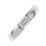 A platinum diamond single-stone ring. The rectangular-shape diamond, with tapered band. Estimated