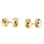 A pair of early 20th century 18ct gold ruby and sapphire cufflinks. Each designed as two oval-