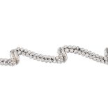 An 18ct gold diamond bracelet. Designed as a stylised ribbon, the brilliant-cut diamond scrolling