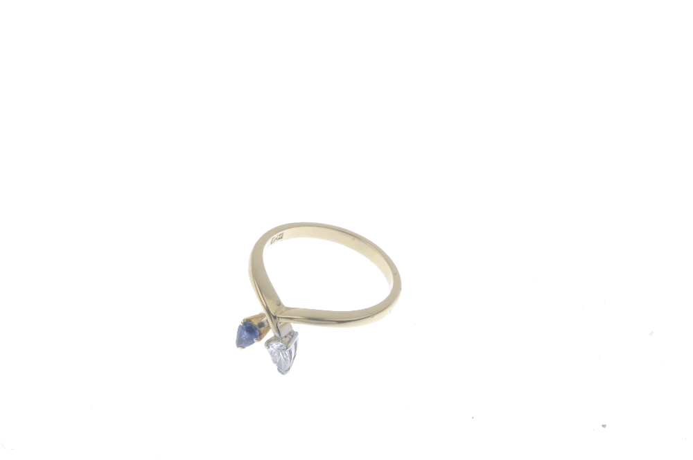 An 18ct gold diamond and sapphire dress ring. The crossover band, with pear-shape diamond and - Image 3 of 4