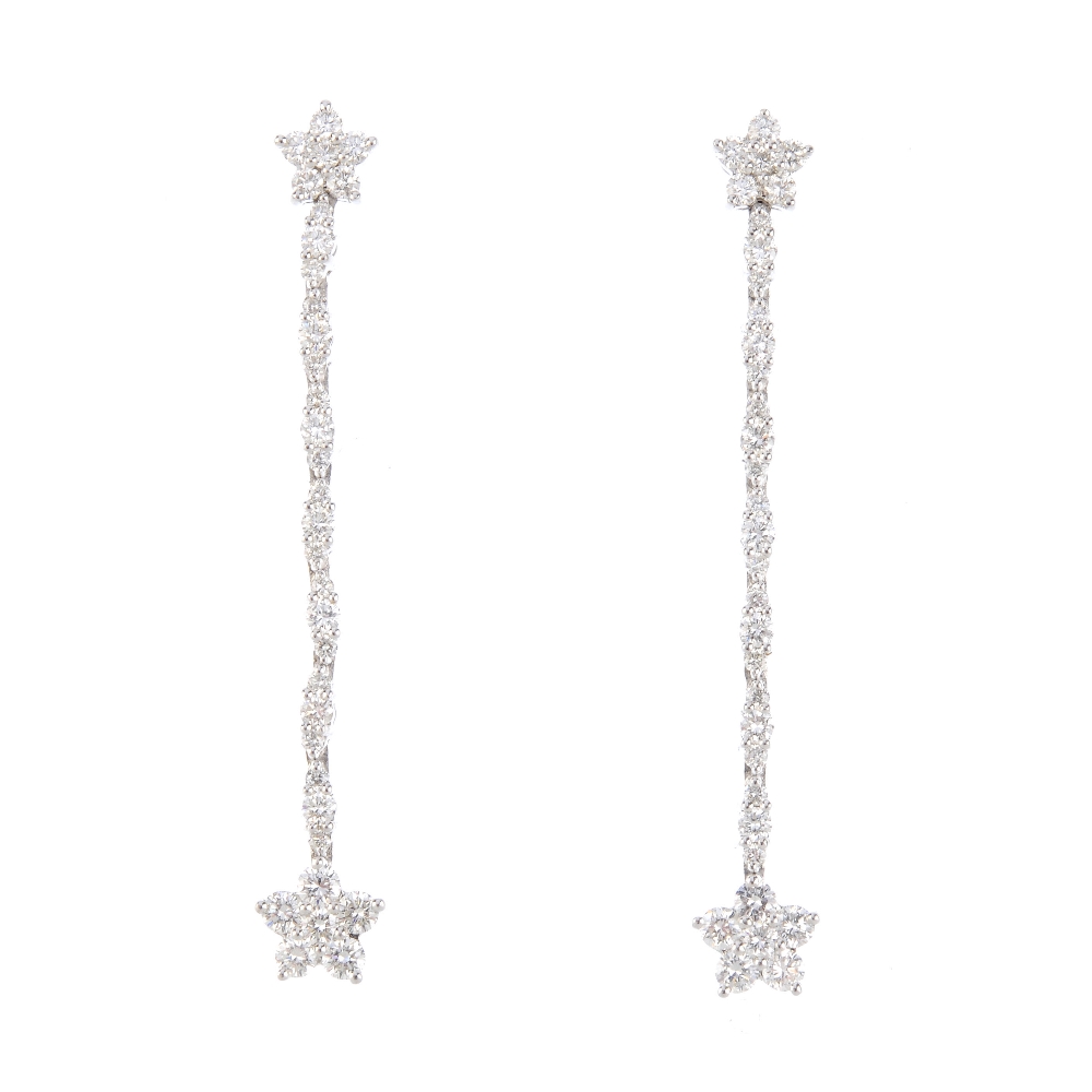 A pair of diamond earrings. Each designed as a brilliant-cut diamond cluster, suspended from a