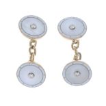 A pair of 9ct gold diamond and gem-set cufflinks. Each designed as a mother-of-pearl disc with