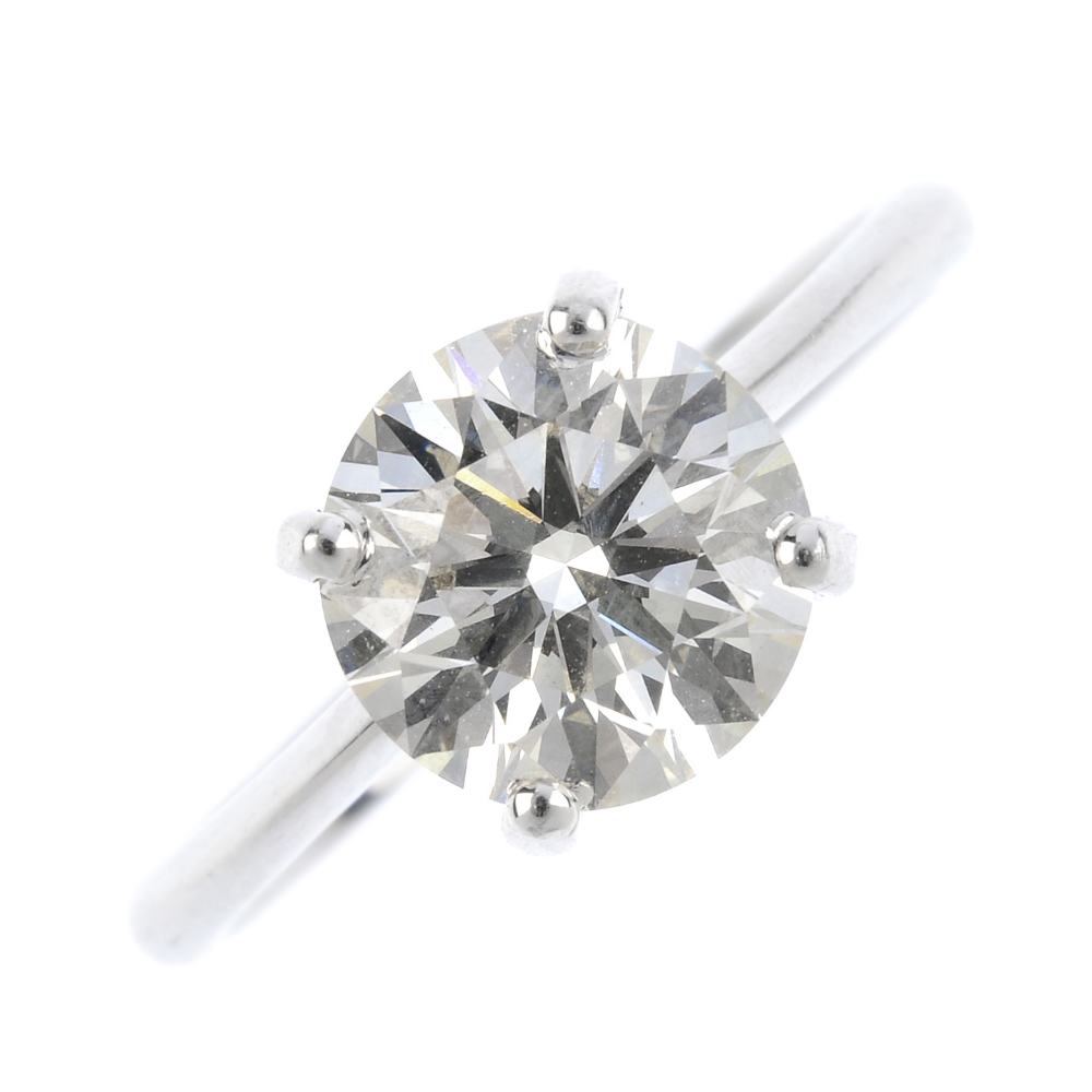 An 18ct gold diamond single-stone ring. The brilliant-cut diamond, with tapered shoulders and