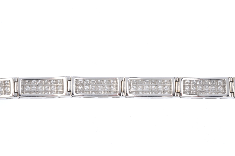 A diamond bracelet. Designed as three brilliant-cut diamond lines, with polished bar spacers and - Image 2 of 3
