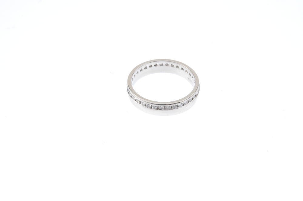 A platinum diamond full-circle eternity ring. The brilliant-cut diamond line, within an off-centre - Image 2 of 2