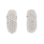 A pair of diamond earrings. Each hoop designed as a pave-set diamond curved panel, with hinged