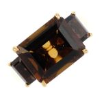 An 18ct gold smokey quartz dress ring. The rectangular-shape smokey quartz, with similarly-shaped