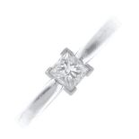 A platinum diamond single-stone ring. The square-shape diamond, with openwork gallery and tapered