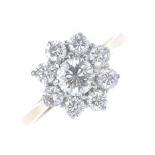 An 18ct gold diamond cluster ring. The brilliant-cut diamond, within a similarly-cut diamond