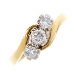 An 18ct gold diamond three-stone ring. Designed as a brilliant-cut diamond diagonal line, with