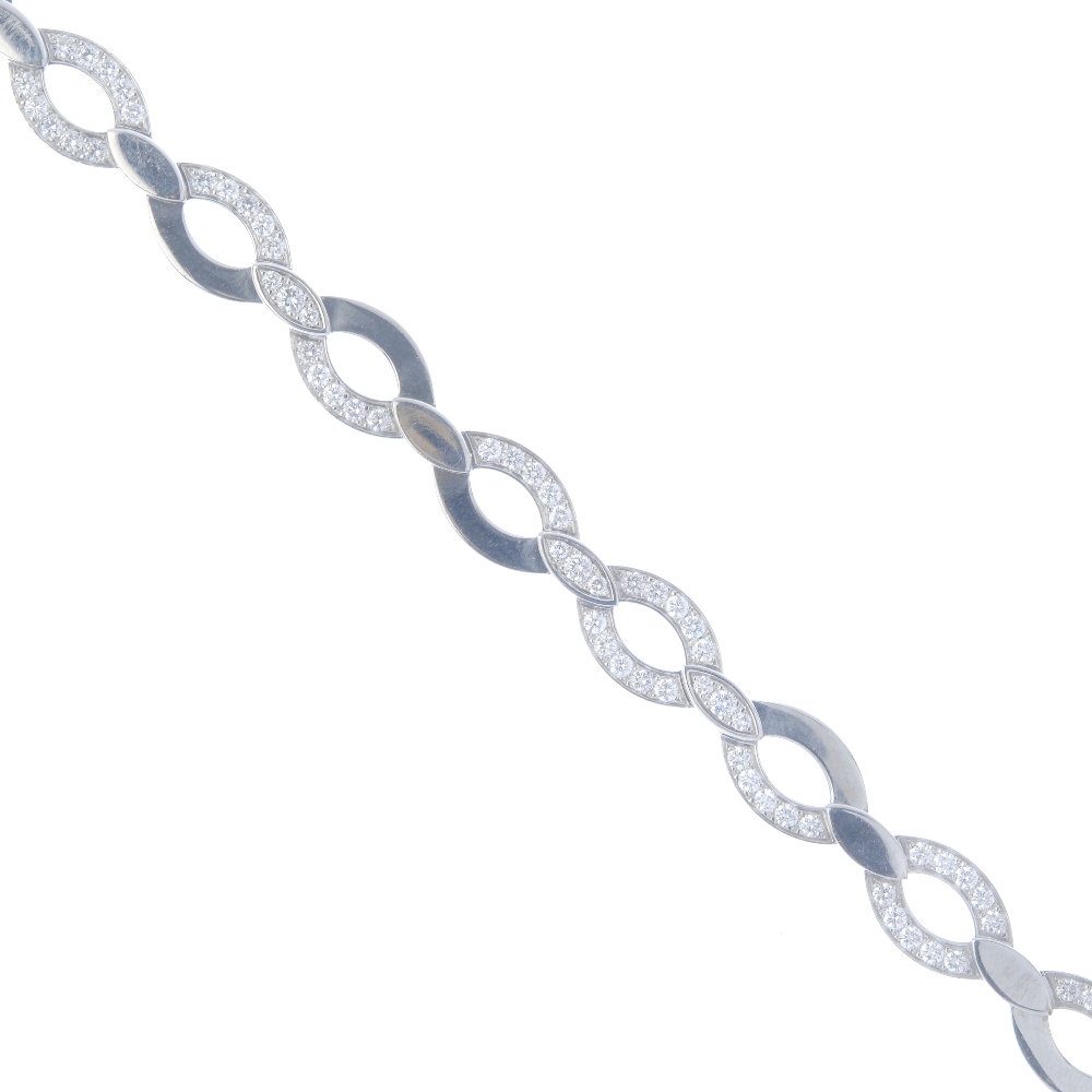 CARTIER - a diamond necklace. Designed as a series of oval links, with brilliant-cut diamond