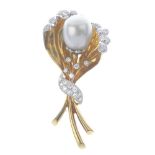 An 18ct gold cultured pearl and diamond brooch. Of floral design, the cultured pearl, within a