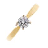 An 18ct gold diamond single-stone ring. The brilliant-cut diamond, with tapered shoulders and