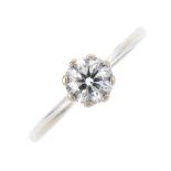 A 9ct gold diamond single-stone ring. The brilliant-cut diamond, with tapered shoulders and plain