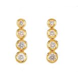 A pair of 18ct gold diamond earrings. Each designed as a graduated brilliant-cut diamond collet