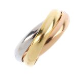 MUST DE CARTIER - a 'Trinity' ring. Comprising three, tri-colour, entwined bands. Signed and