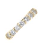 An 18ct gold diamond seven-stone ring. The brilliant-cut diamond line, with bar spacers and plain