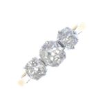 A mid 20th century 18ct gold diamond three-stone ring. The graduated old-cut diamond line, with bi-