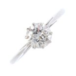 A mid 20th century platinum diamond single-stone ring. The brilliant-cut diamond, with tapered