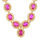 A glass-filled ruby and diamond necklace. Designed as a series of oval-shape glass-filled ruby and