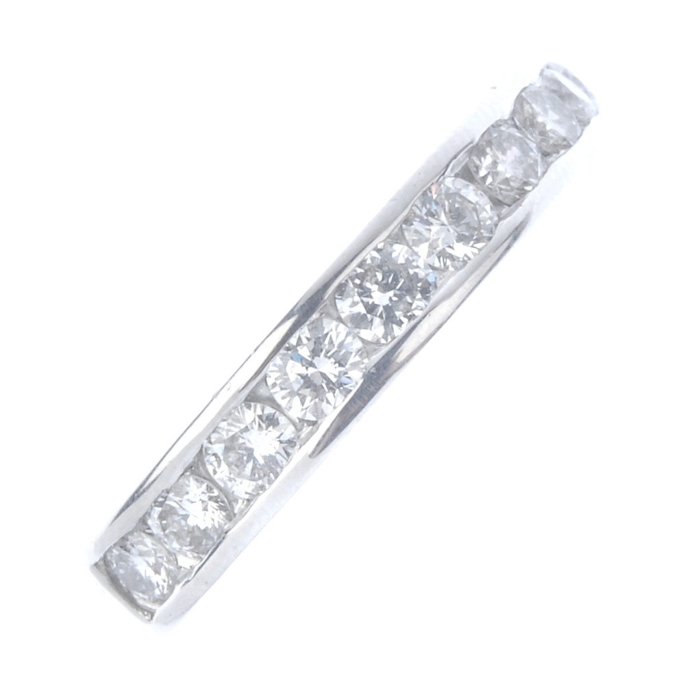 An 18ct gold diamond half-circle eternity ring. The brilliant-cut diamond line, inset to the plain