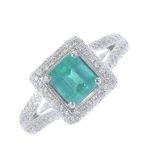 An emerald and diamond cluster ring. The square-shape emerald, within a brilliant-cut diamond