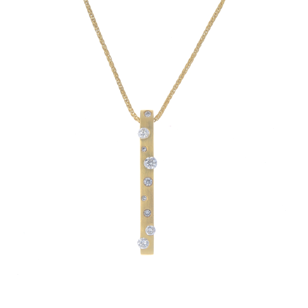 An 18ct gold diamond pendant. The slightly textured bar, with vari-size brilliant-cut diamond