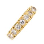 An 18ct gold diamond ring. The brilliant-cut diamond line, with tapered shoulders. Estimated total