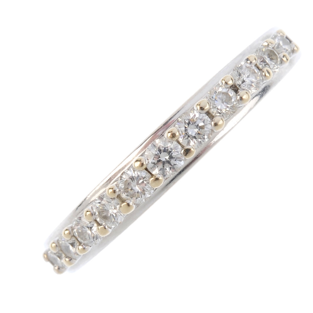 An 18ct gold diamond half-circle eternity ring. The graduated brilliant-cut diamond line, with