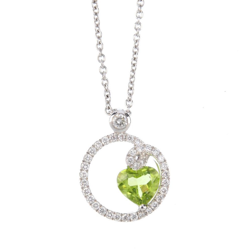 A peridot and diamond pendant. The heart-shape peridot, offset to the brilliant-cut diamond openwork