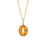 An 18ct gold citrine and diamond pendant. The oval-shape citrine, within a circular-shape citrine